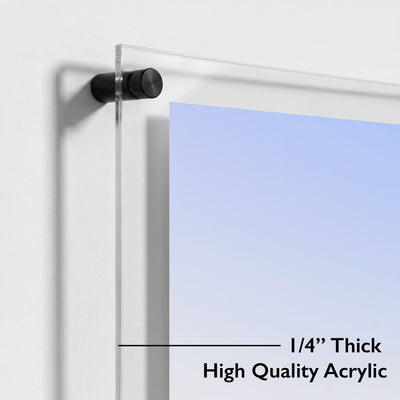 Close up of black mounting hardware securing a clear acrylic wall art panel