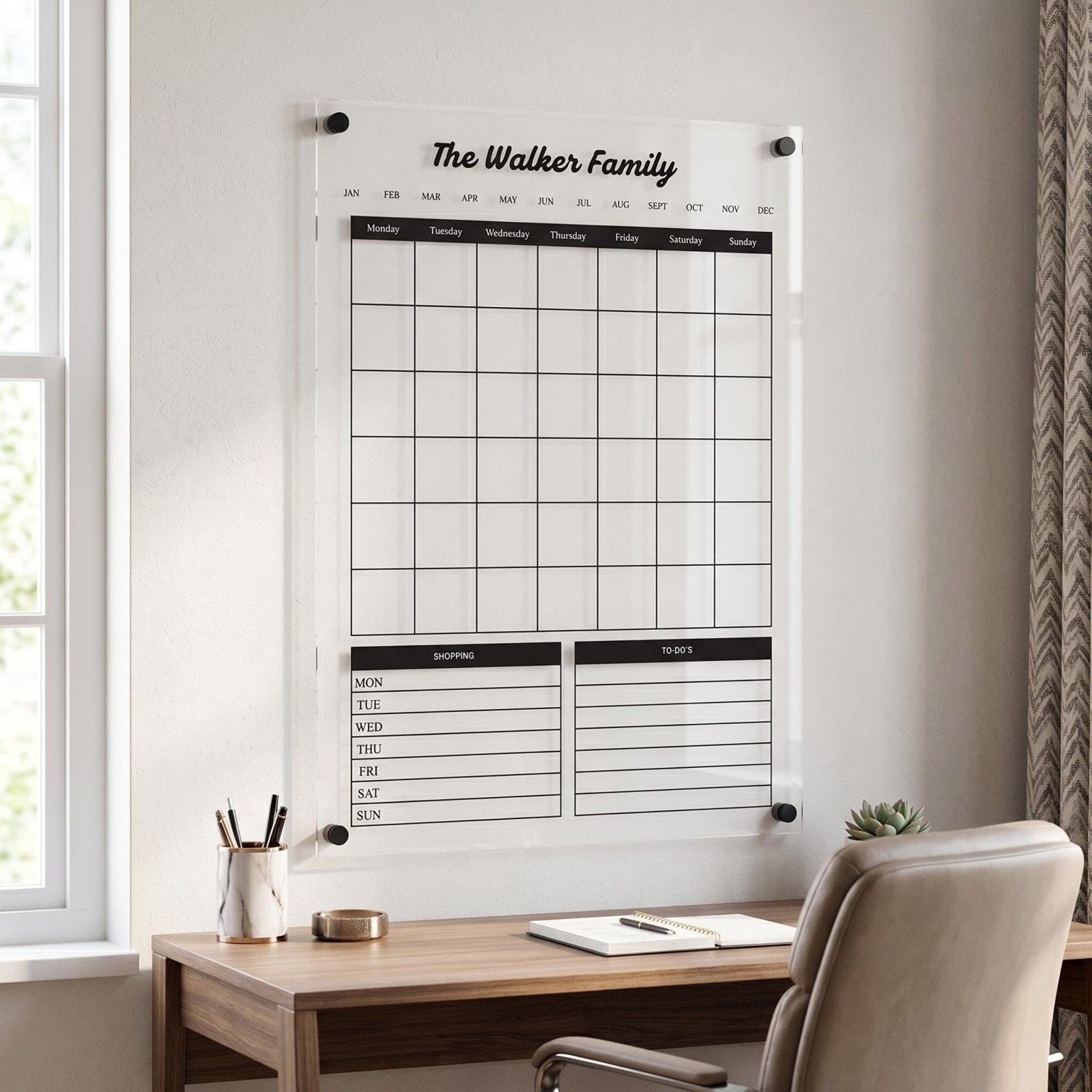 Personalized acrylic wall calendar displayed above a home office desk