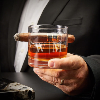 custom engraved oxley cigar glass with whiskey held by a man 