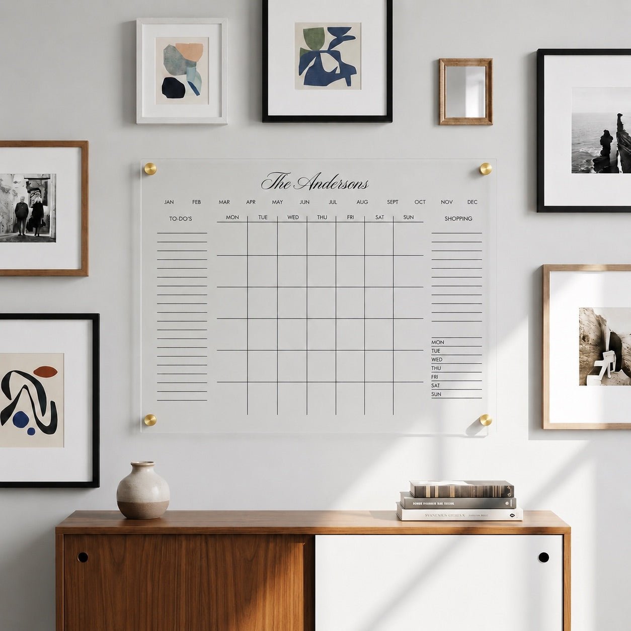 Personalized acrylic wall calendar displayed above a wood cabinet