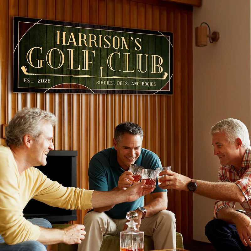 Three men clink whiskey glasses in a room with a wall sign reading “Harrison’s Golf Club”.